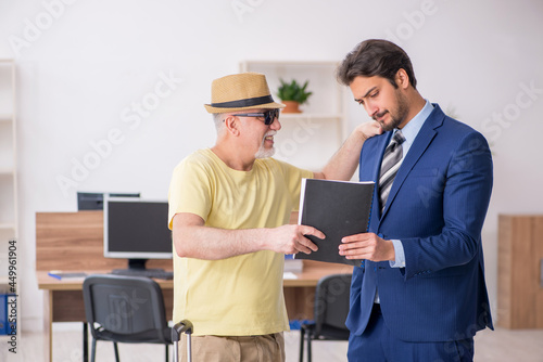 Old boss and young male employee in summer vacation concept