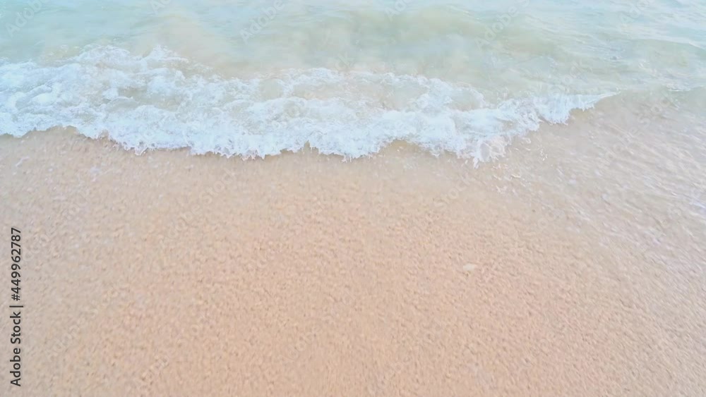 Close-up texture of the surface of a sea or ocean wave that comes to the sandy coast. Natural background with splashes of water and foam. Slow motion vacation summer concept Close-up texture of the surface of a sea or ocean wave that comes to the sandy coast. Natural background with splashes of water and foam. Slow motion vacation summer concept