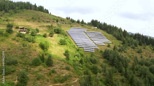 Solar panel produces green, environmentaly friendly energy from the setting sun. Mountainous solar farm, Solar panels farm field that is located on the bulgarian hills.