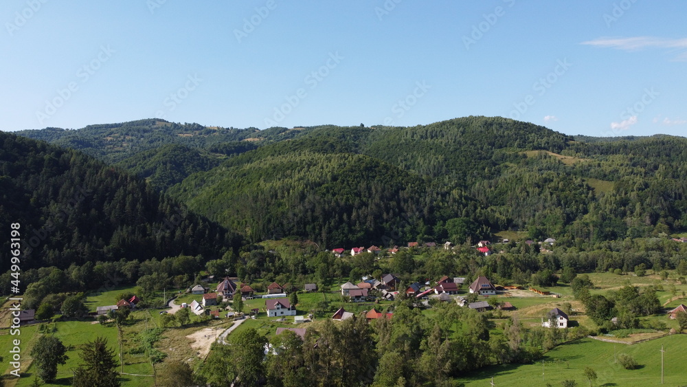 Panorama with hills, forest and village.