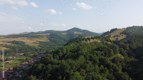 Panorama with hills, forest and village.