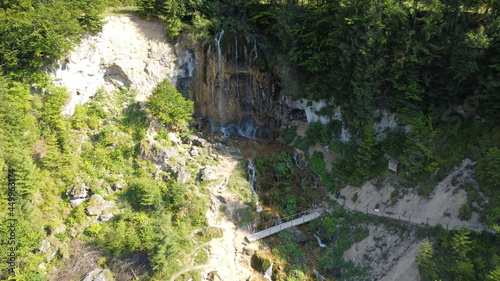 Waterfall in the national park. Waterfall full of mosses. Waterfall Pisoaia photo