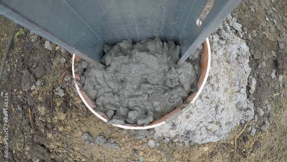 Time lapse of a worker using a trowel to fill the mold with cement, construction Time lapse of a worker using a trowel to fill the mold with cement, construction