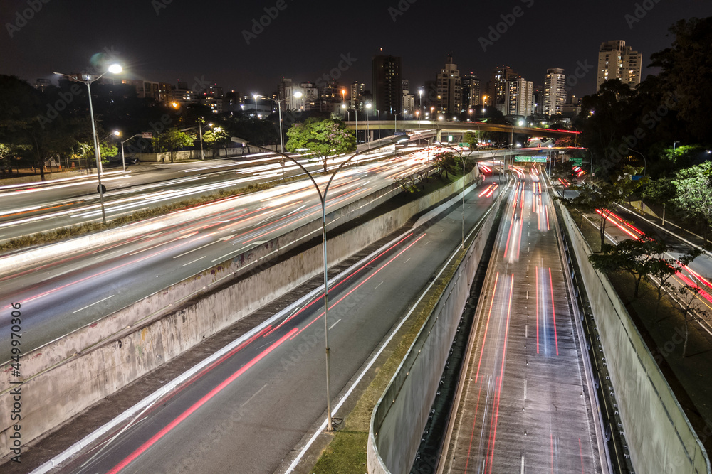 Fototapeta premium Sao Paulo, Brazil, July 14 2021.Night time lapse of traffic on the famous 23 de Maio Avenue in Sao Paulo, Brazil. This avenue run past Ibirapuera Park.