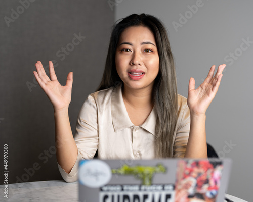 Young Edgy Asian Female Data Scientist Explaining The Scope of a Marketing Analytics Results