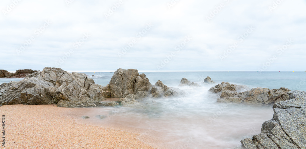 beach and sea with waves and rocks