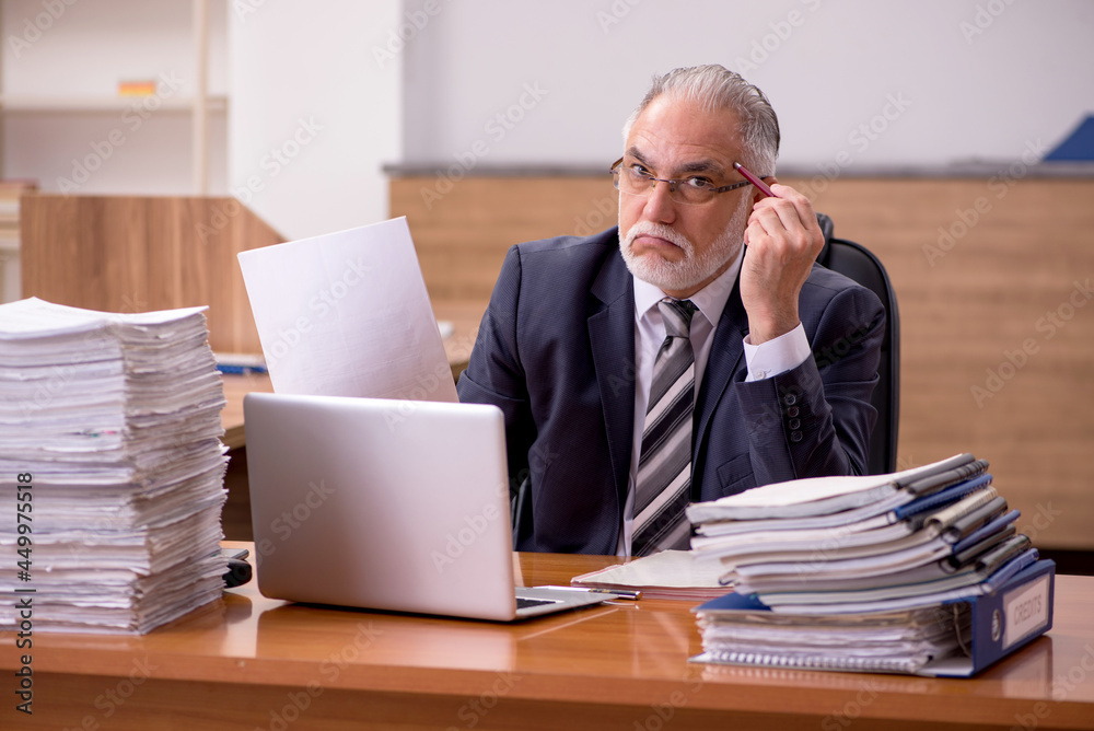 Old male employee and too much work in the office Old male employee and too much work in the office