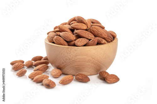 Almonds in a wooden bowl on white photo