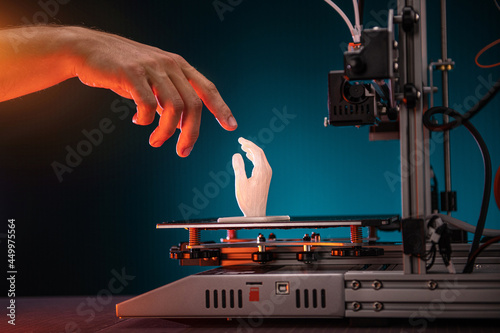 Obraz na płótnie 3D printing in progress. 3d printer printed a hand. A man touches the product printed on a 3d printer. God's touch, biblical motives w salonie