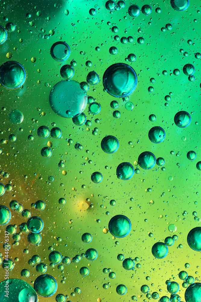 oil bubbles with water on glass
