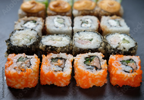 Japanese food. Sushi. Philadelphia roll with fresh salmon, cucumber, avocado, cream cheese, tobiko caviar.
