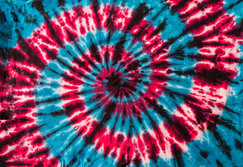 Fashionable Colorful Red, Blue and Black Retro Abstract Psychedelic Tie Dye Swirl Design on cotton shirt. 
