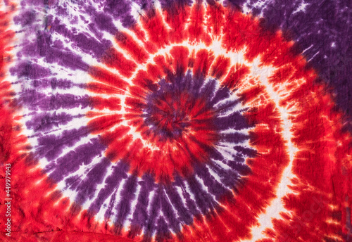 Fashionable Colorful Red, Blue and Black Retro Abstract Psychedelic Tie Dye Swirl Design on cotton shirt. 