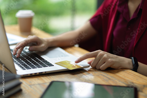 Female entering credit card number and security code via laptop