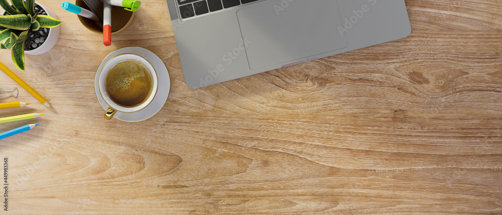 Wooden background with laptop keyboard, coffee, stationery, and copy space Wooden background with laptop keyboard, coffee, stationery, and copy space