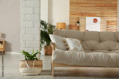 Light room interior with stylish wooden sofa. Idea for design