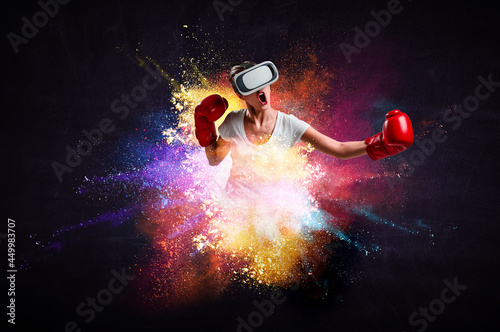 Young woman boxing in VR glasses