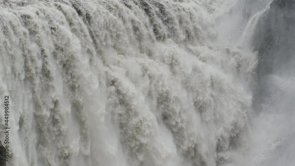 Tightly framed shot of Dettifoss Waterfall demonstrating its incredible power as it crashes onto the rock formations below. Famous Icelandic Landmark.