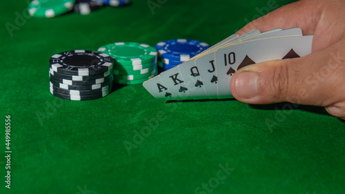 Casino games concept,Stacks of poker chipson gamble table including red, black, white, green and blue on a white background. photo