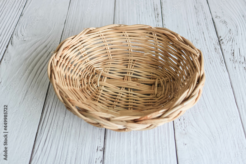 Fototapeta premium Empty weaved basket on the wooden table.