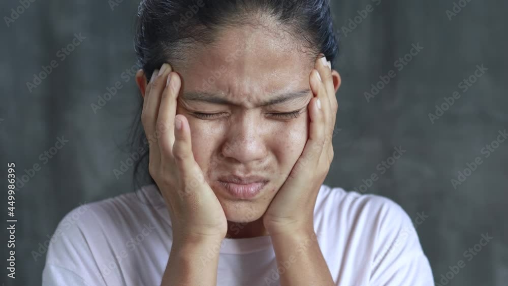 Close up young asian woman has migraine headache Close up young asian woman has migraine headache