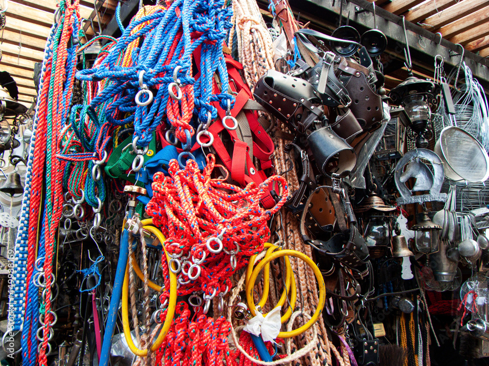 A pile of different goods to use for horses as halters, bridles, ropes and others for sale at the outdoor market in Cuenca, Ecuador