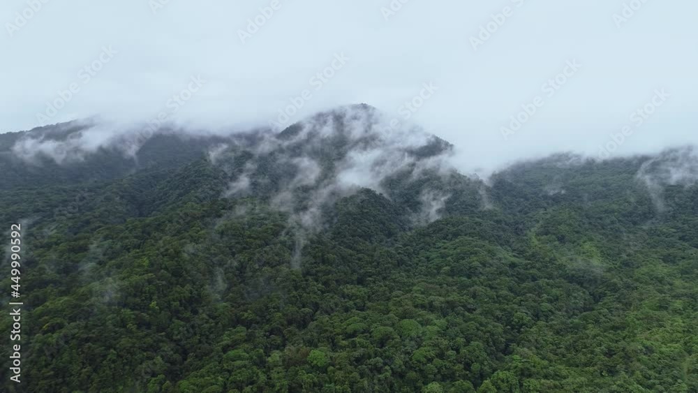 Aerial shot moving away from cloud covered jungle mountains in rain forest, 4K Aerial shot moving away from cloud covered jungle mountains in rain forest, 4K