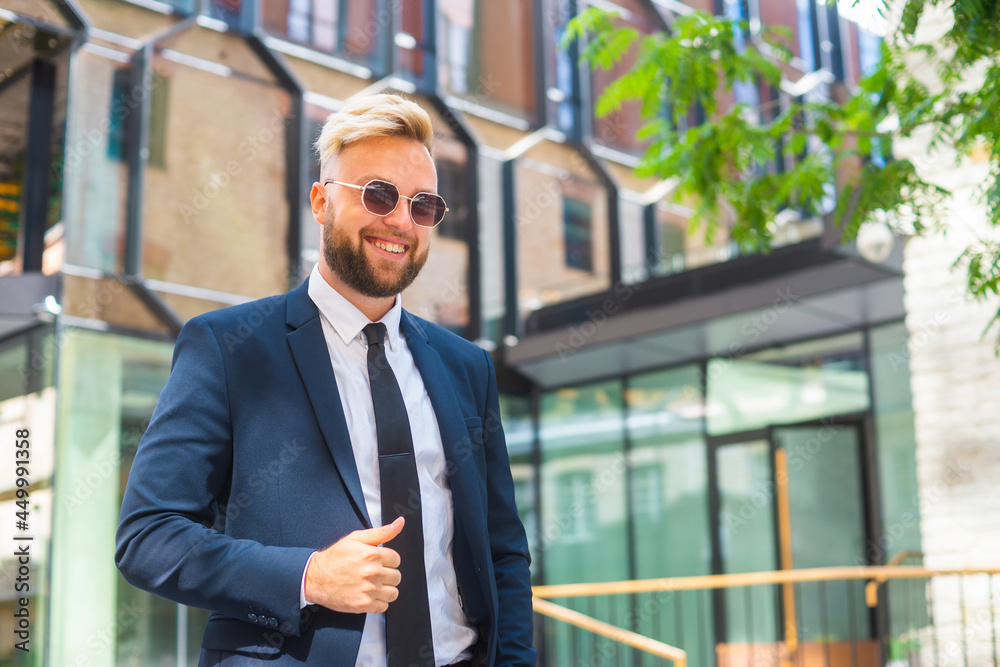Confident businessman in front of modern office building. Financial investor is walking outdoor. Banking and business. Confident businessman in front of modern office building. Financial investor is walking outdoor. Banking and business.
