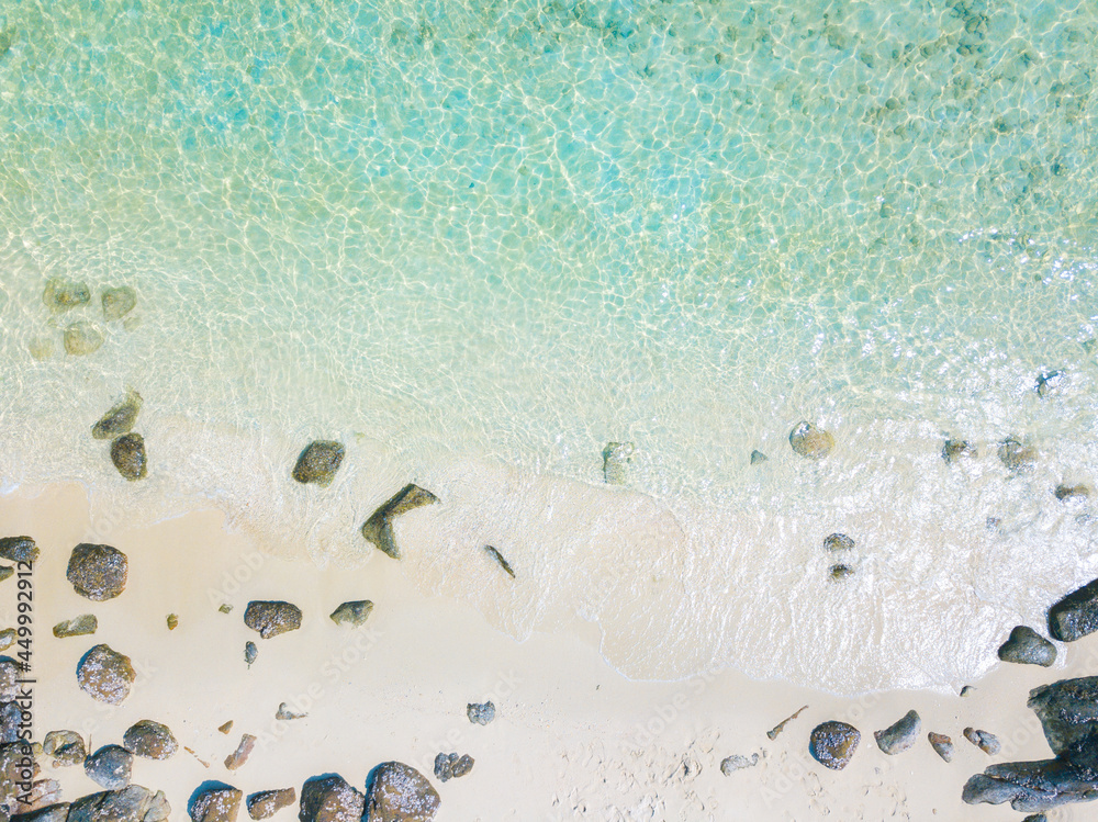 Aerial drone shot of beautiful paradise sand with rock beach with clear turquoise sea. Summer and travel vacation concept
