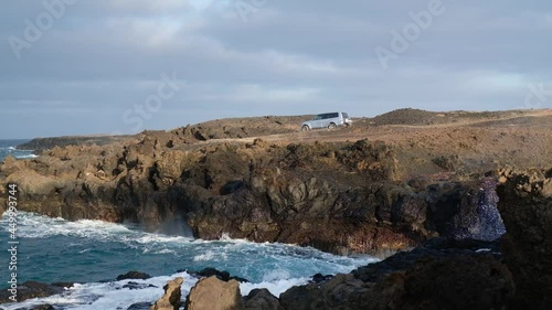 Ocean Waves Crashing On The Rocky Coastline Of Lanzarote, Canary Islands, Spain. wide shot photo