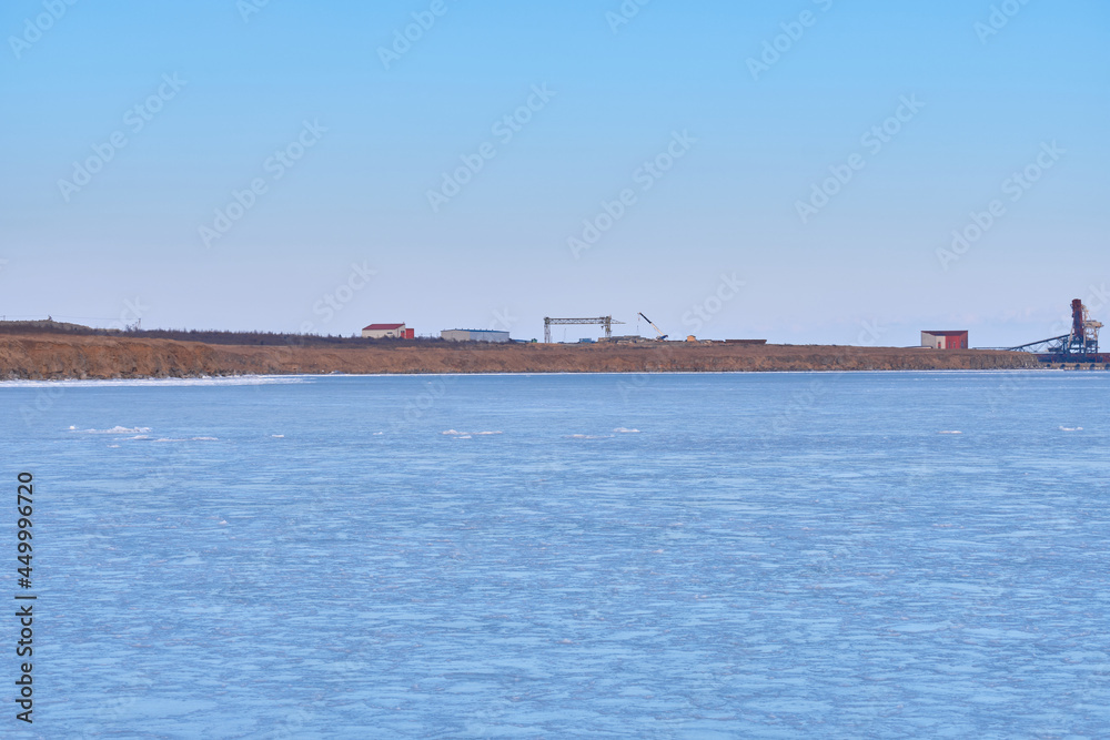 Vanino, Russia - Jan 18, 2021: Vanino Bay in the Tatar Strait in winter. The frozen sea.