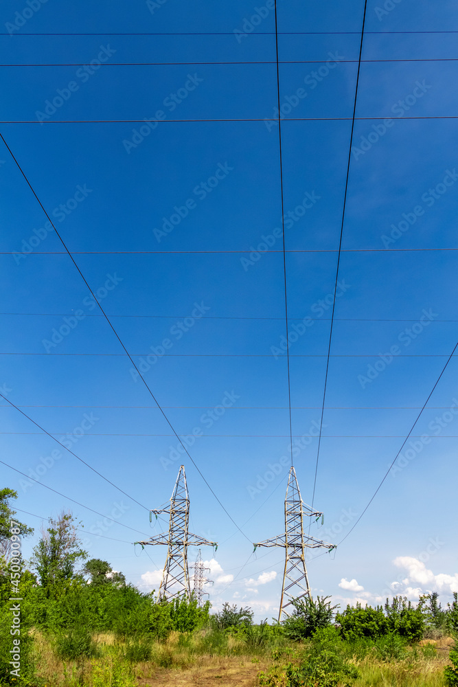 High voltage electrical lines and equipment against the blue sky.
