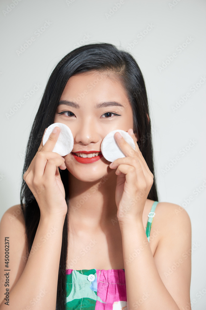 Beauty woman having fun with cotton pad isolated on white background. Skin care and beauty concept. Beauty woman having fun with cotton pad isolated on white background. Skin care and beauty concept.