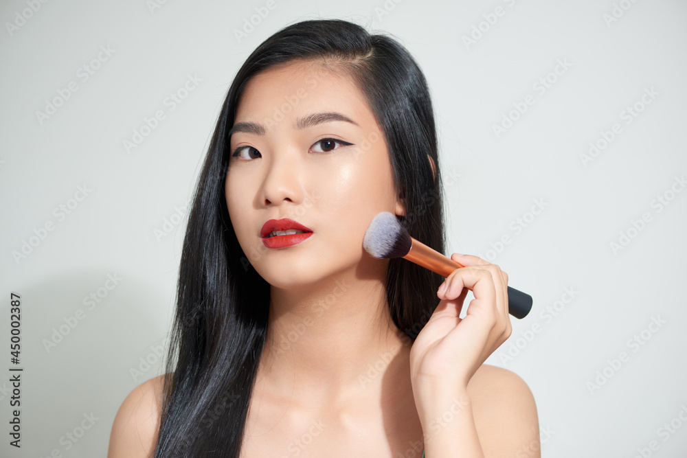 Beauty asian woman hold make up brush and cheerful with make up brush Beauty asian woman hold make up brush and cheerful with make up brush