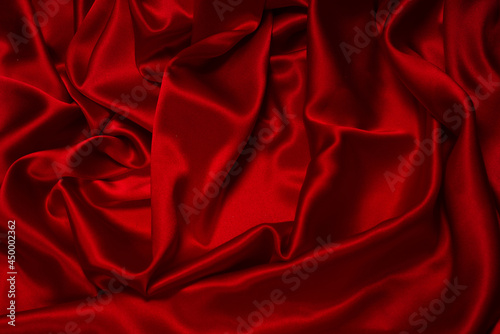 Rich and luxury red silk fabric texture background.