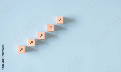 Business concept growth success process, Minimal Wood block stacking as step stair on paper blue background, copy space.