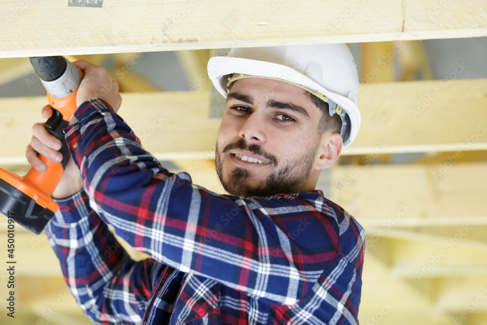 casual man doing works at home with drill casual man doing works at home with drill
