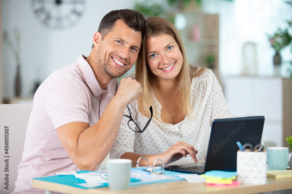 couple doing accounting in the living room at home couple doing accounting in the living room at home