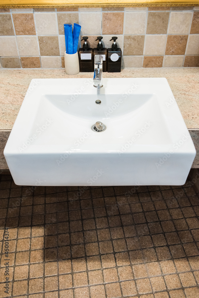 Top view of chrome faucet washbasin. Interior of bathroom with sink basin faucet. Top view of chrome faucet washbasin. Interior of bathroom with sink basin faucet.