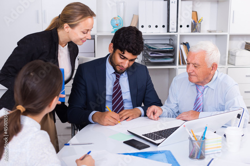 Employees are writing financial reports in the office.