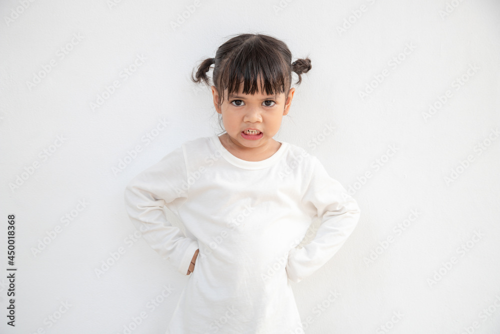 Angry little girl over white background, sign and gesture concept Angry little girl over white background, sign and gesture concept