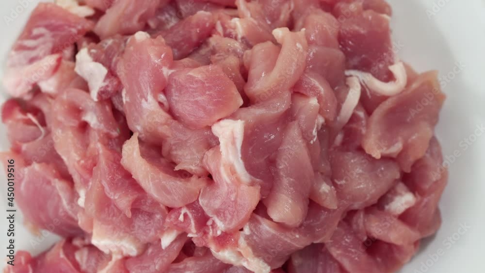 Raw minced pork on white plate with rotating, Top view
