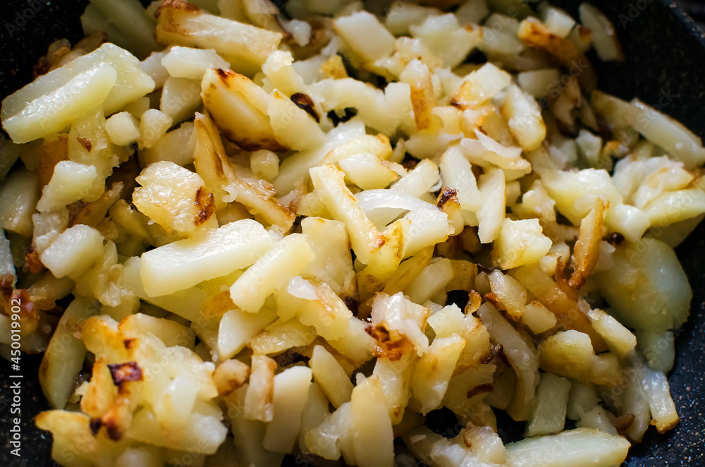 Delicious fried potatoes with onions. Close-up, top view. Delicious fried potatoes with onions. Close-up, top view.