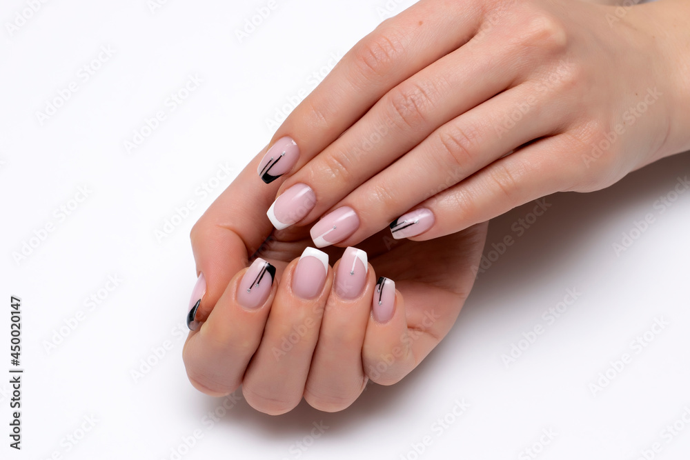 Wedding manicure. French black, white manicure with stripes and silver dots on a long close-up of ballero nails against a white background. Gel nail design. Wedding manicure. French black, white manicure with stripes and silver dots on a long close-up of ballero nails against a white background. Gel nail design.