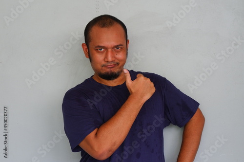 Young asian man smiling and thumbs up gesture photo