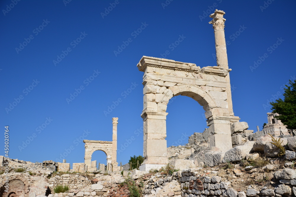 ruins of ancient town Sagalassos with gates and stones on blue sky background