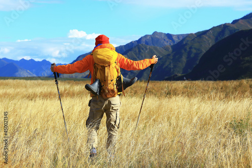 trekking mountains man walking sticks travel adventure man with backpack