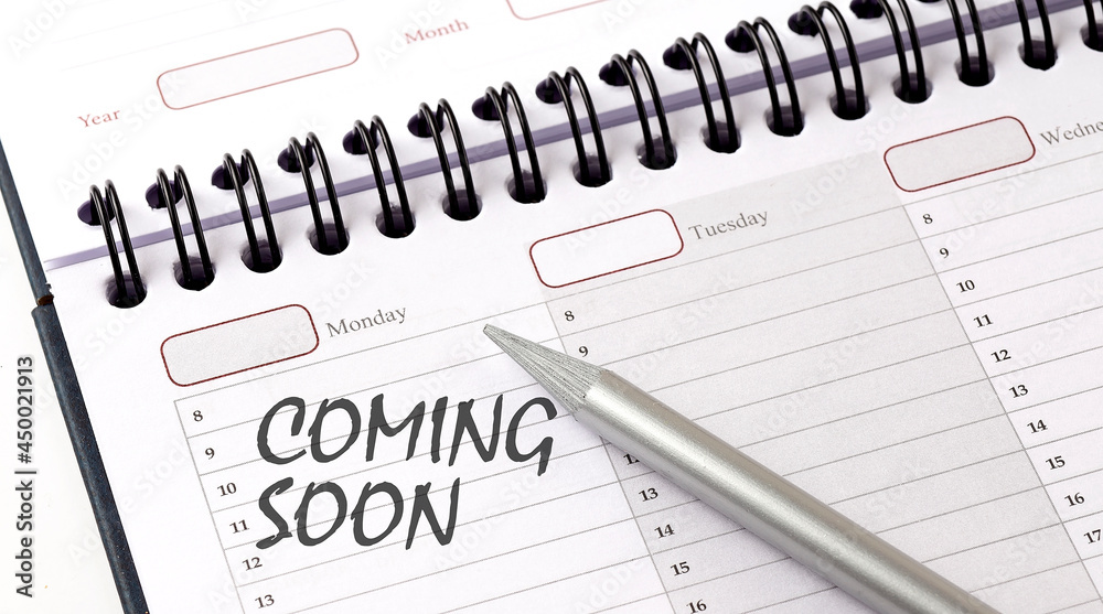 COMING SOON on the planner with pencil, business concept COMING SOON on the planner with pencil, business concept