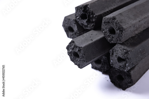 activated carbon of macadamia shell charcoal briquettes isolated on white background