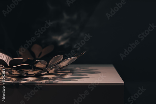 Metal dish on the background of a dark wall. Interior details